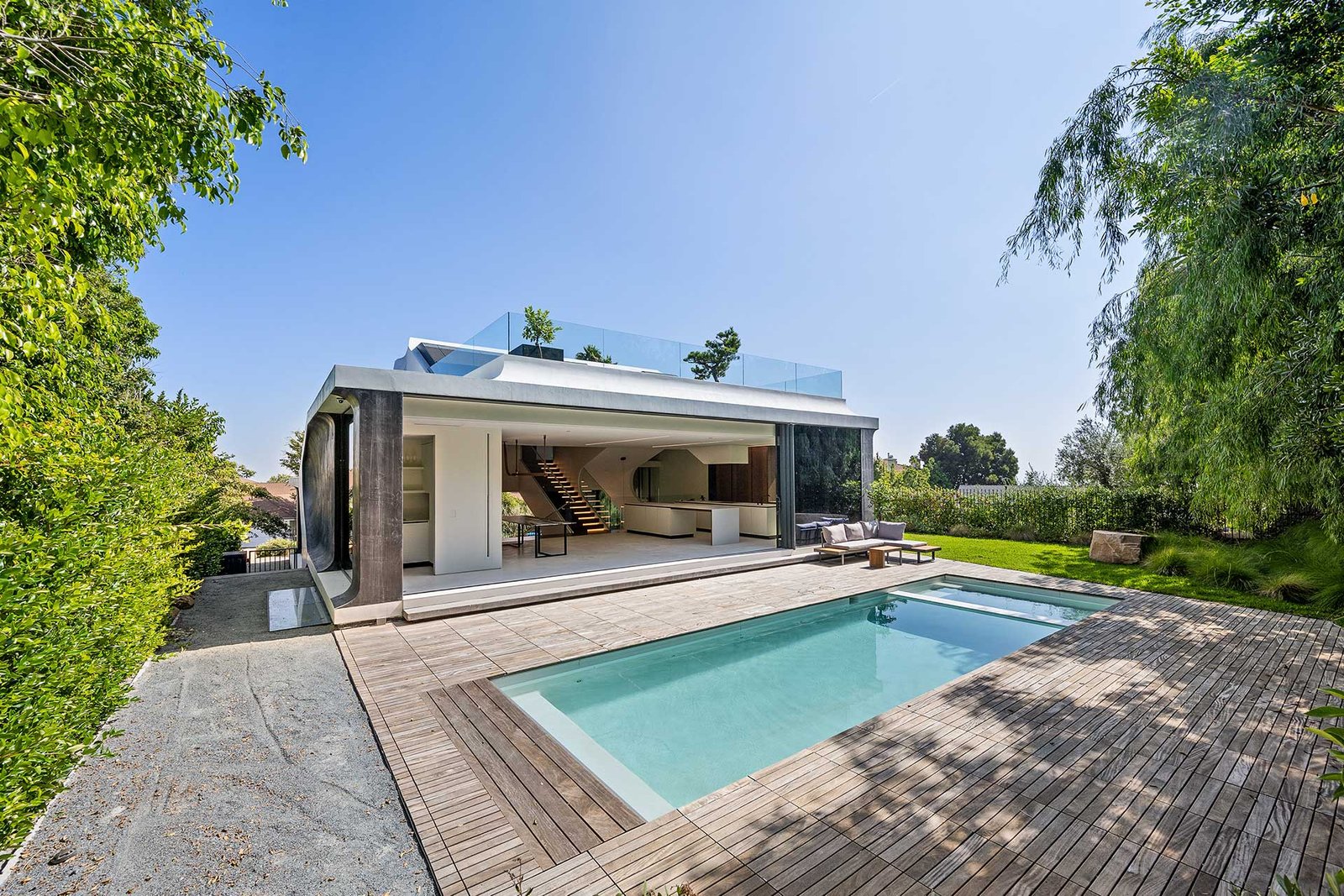 an-open-swimming-pool-is-in-the-backyard-of-a-home-SRNTQ4N.jpg